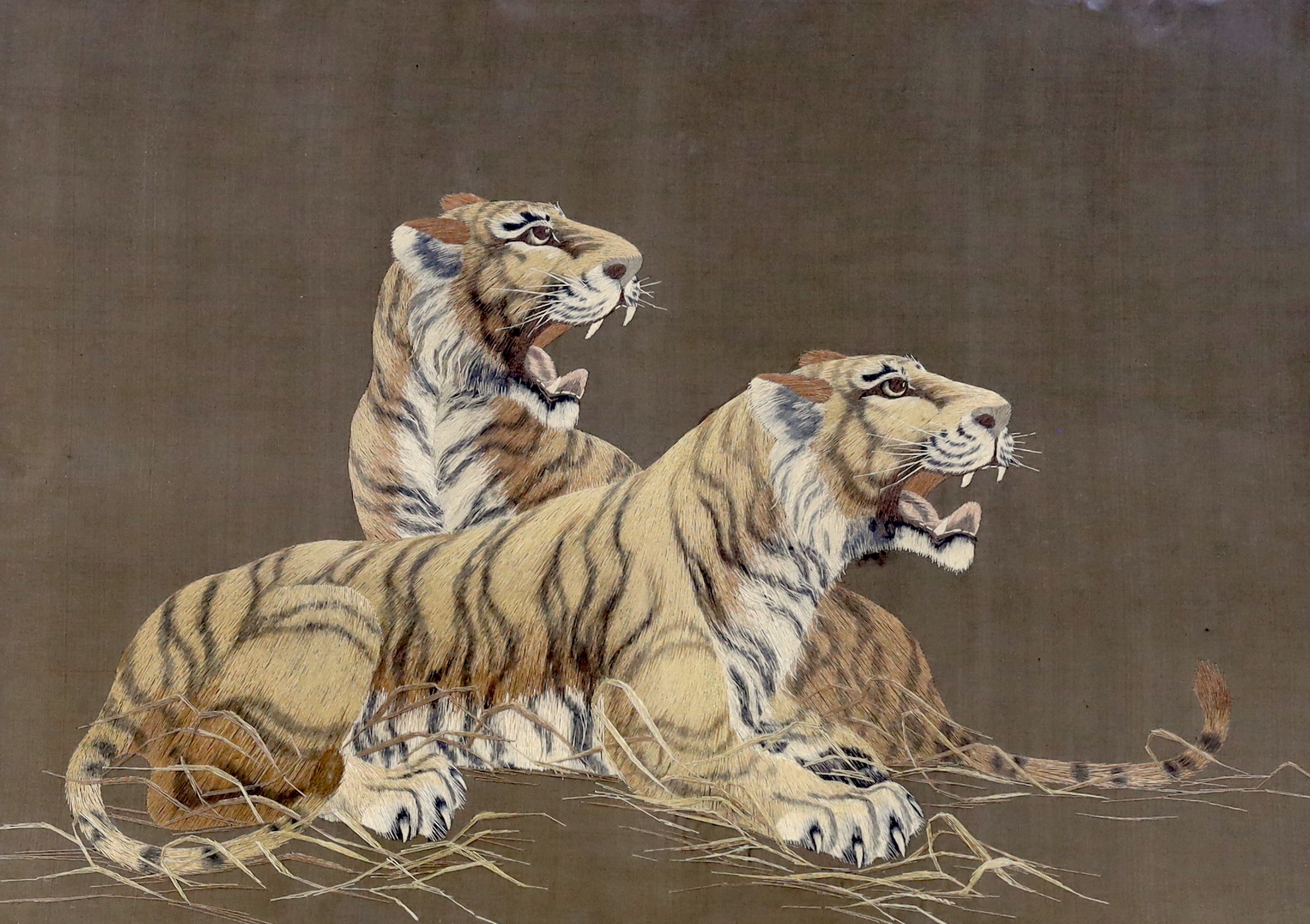 A Japanese silk panel embroidered with two tigers, 53 x 39cm